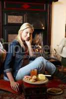 Young woman making toast on open fire