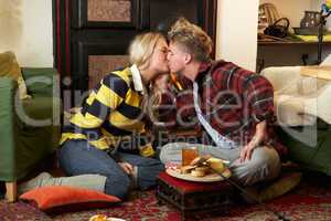 Young couple making toast on open fire