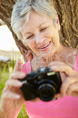 Senior woman with camera