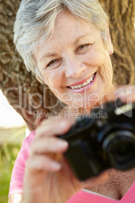 Senior woman with camera