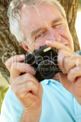 Senior man with camera