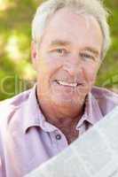 Senior man reading newspaper