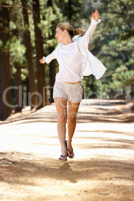 Woman running along country lane