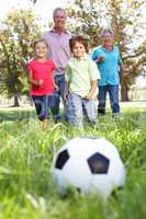 Grandparents playing football with grandchilderen