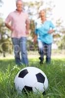 Senior couple playing football