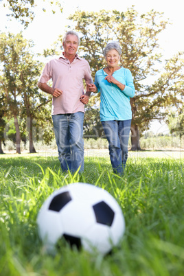 Senior couple playing football