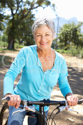 Senior woman on country bike ride
