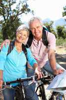 Senior couple with map on country bike ride