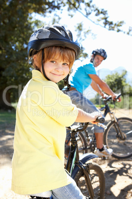 Little boy on country bike ride with dad