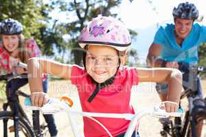 Young family on country bike ride