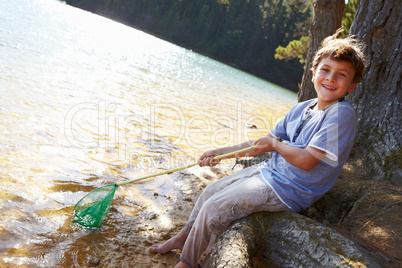 Happy boy fishing at lake
