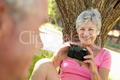Senior woman with camera