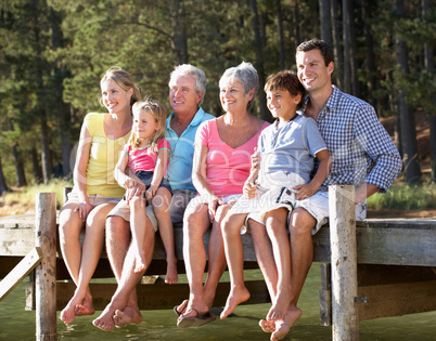 3 Generation family sitting by lake