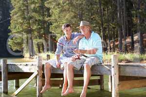 Father and adult son fishing together