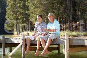 Father and adult son fishing together