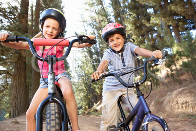 Young children on bikes in country