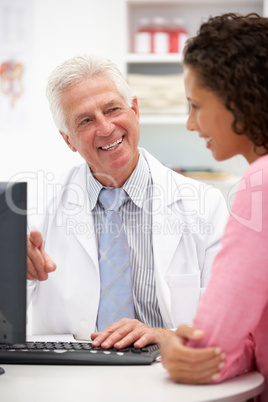 Senior doctor with female patient