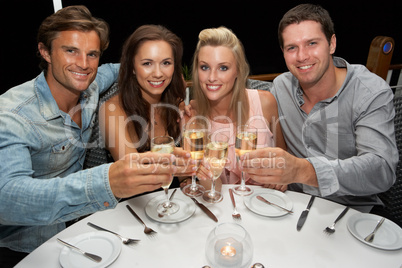 Two young couples in restaurant