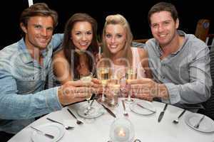 Two young couples in restaurant