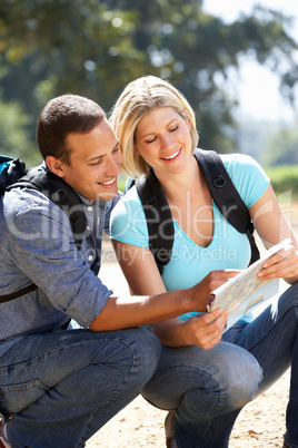 Couple with map on country walk