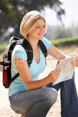 Woman with map on country walk