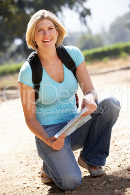 Woman with map on country walk