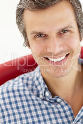 Man sitting in red chair