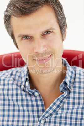 Man sitting in red chair