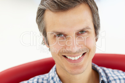 Man sitting in red chair