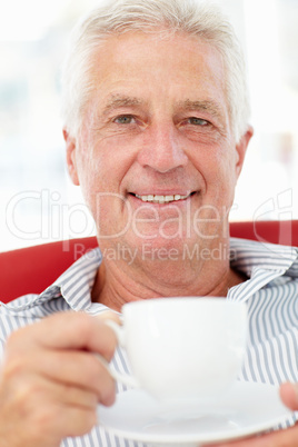 Senior man relaxing with cup of tea