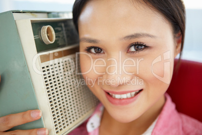 Young woman listening to radio