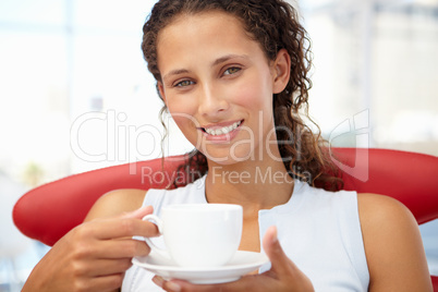 Young woman relaxing with cup of tea