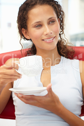 Young woman relaxing with cup of tea