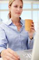 Businesswoman with laptop and coffee