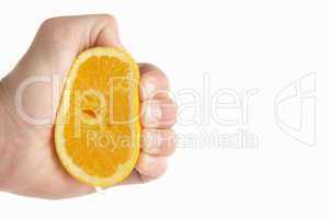 Man's hand squeezing lemon