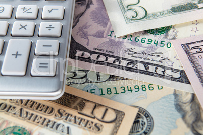 Detail dollar bills and calculator