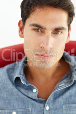 Young man sitting in red chair