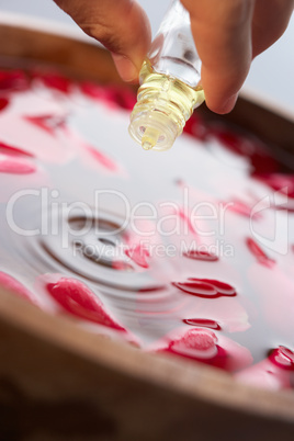 Man pouring essential oil into water