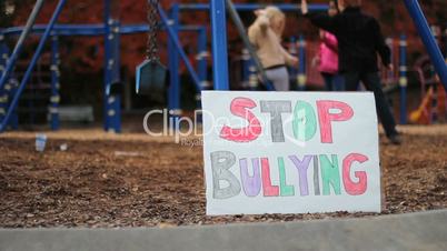 Frightened Girl With Stop Bullying Sign At School