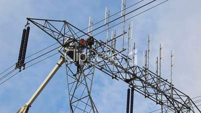 Hydro Worker Climbs Down Ladder On Power Line