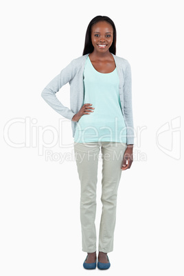 Smiling young woman with hand on her hip Smiling young woman with hand on her hip