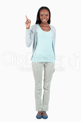 Smiling young woman pointing up Smiling young woman pointing up