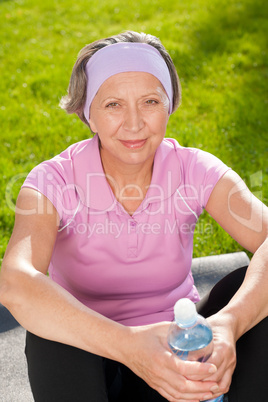 Senior sportive woman happy hold bottle water