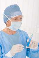 Senior surgeon female hold syringe operation wear