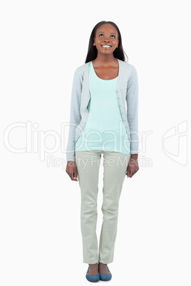 Smiling young woman looking upwards Smiling young woman looking upwards