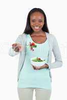 Smiling young woman with salad