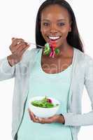 Happy smiling woman eating salad