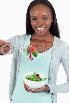 Happy smiling woman offering some salad