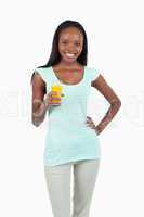 Smiling young woman with a glass of orange juice