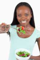 Salad offered by happy smiling woman